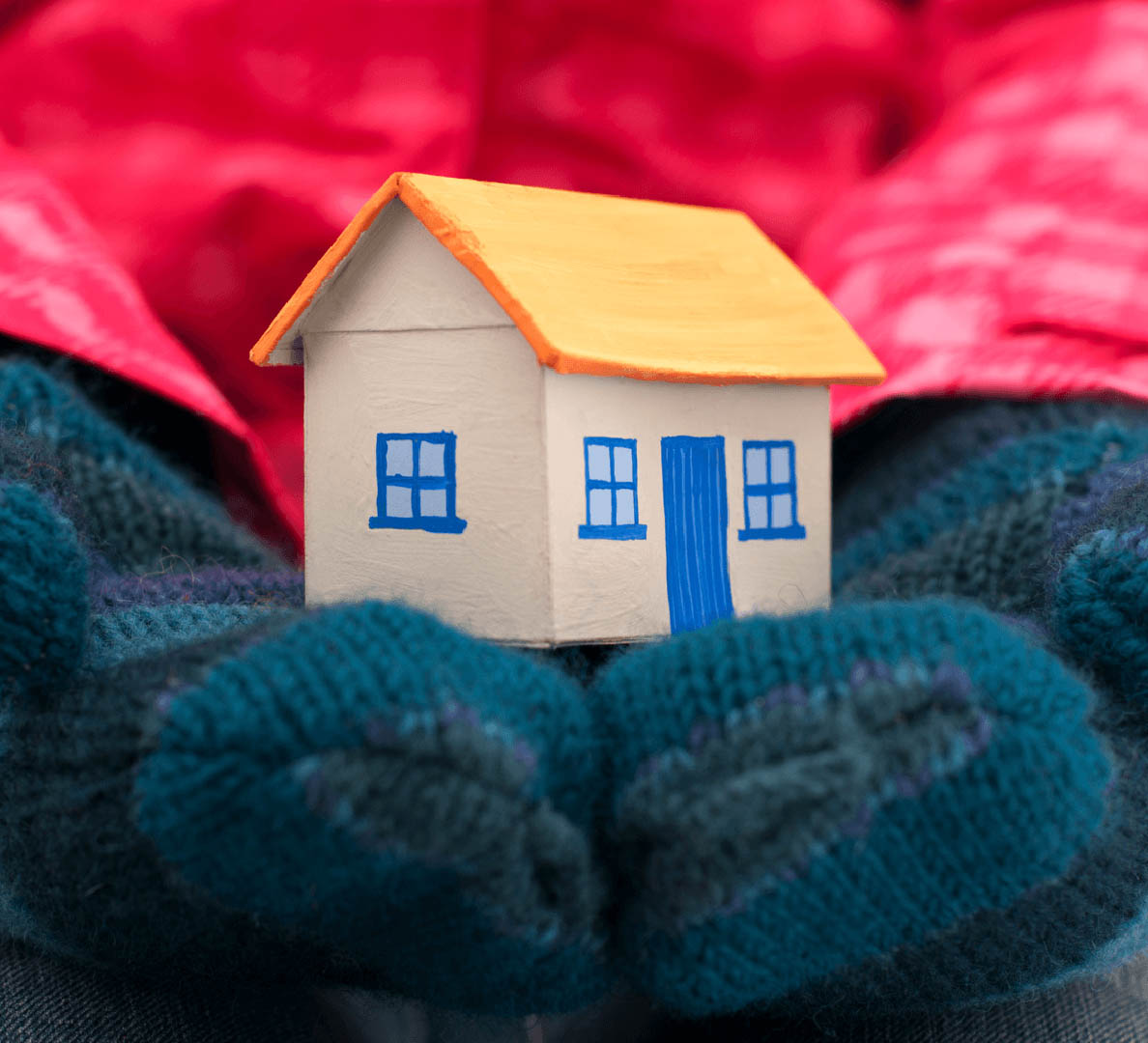 5 Reasons to Buy a New Home in the Winter Gloves Holding Home Image