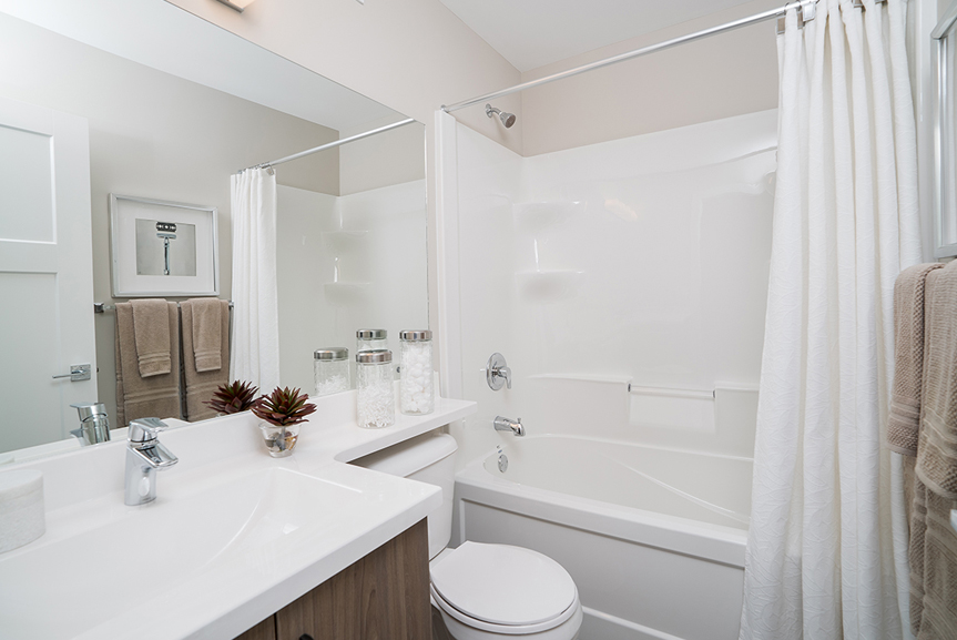 main bathroom with 1-piece acrylic tub and shower, vanity and cultured marble vanity tops broadview homes winnipeg the preston